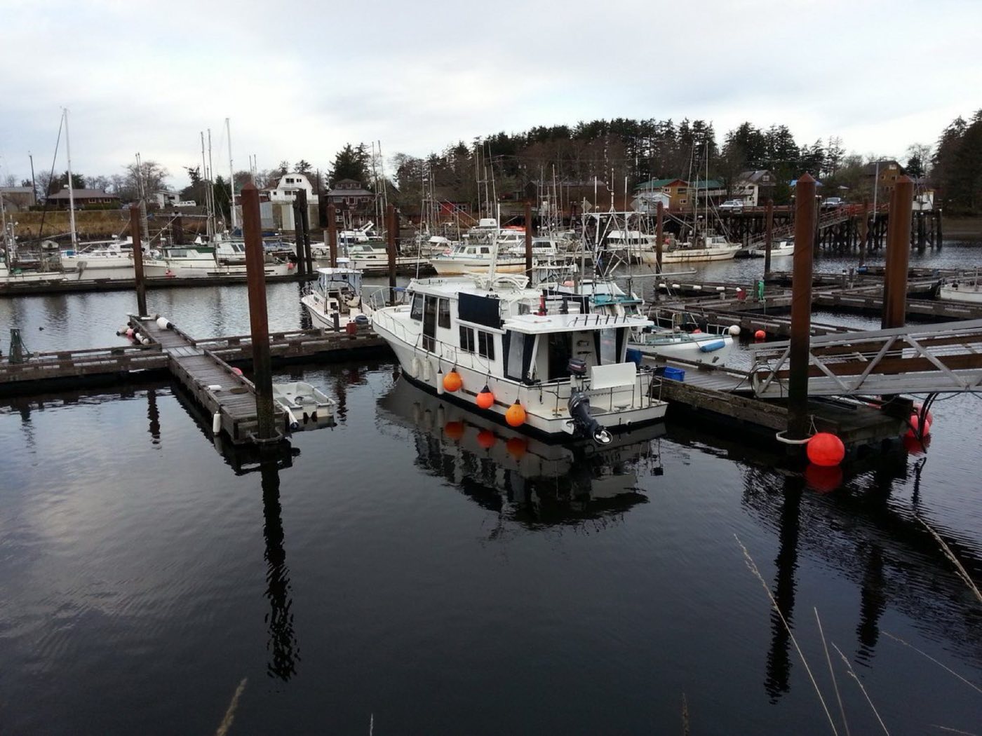 Wooden docks and moored working boats at a small northern marina (placeholder photo)